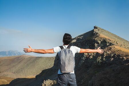 traveler man openning hand  under sky background