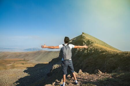 traveler man openning hand  under sky backgroundの写真素材