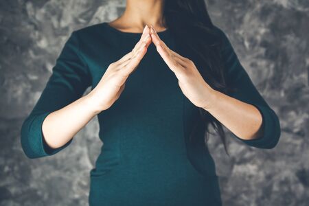 Business woman  two hands in position to protect の写真素材