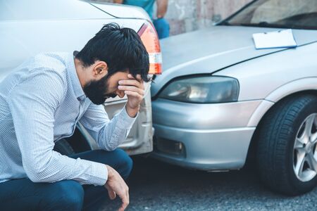 sad man and  car crash accident in streetの写真素材