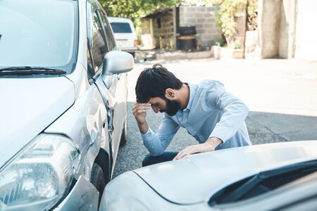 sad man and  car crash accident in streetの写真素材