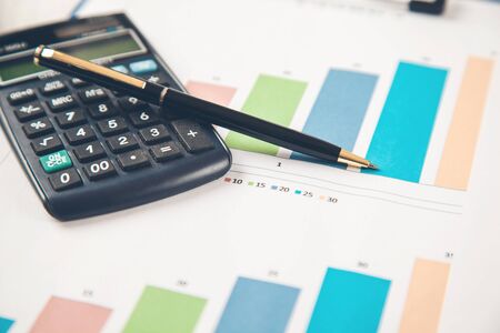 calculator and pen on  graph on the deskの写真素材