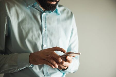 young business man hand holding smart phone