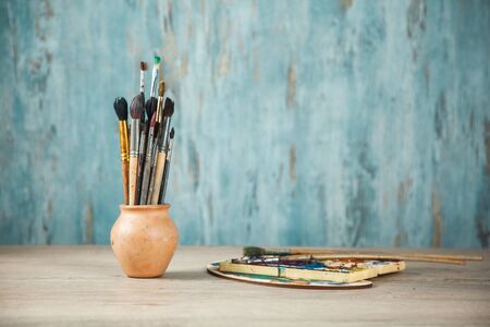 paint brushes on the desk on abstract backgroundの写真素材