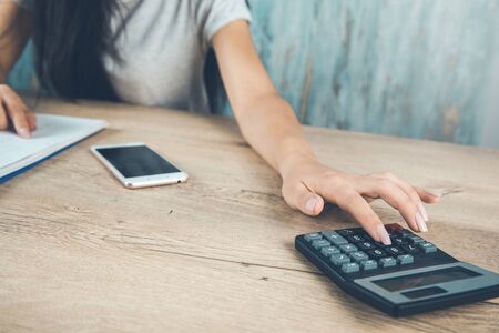 woman working in calculator on the deskの写真素材