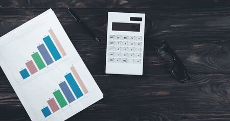 calculator with graph and glasses on desk