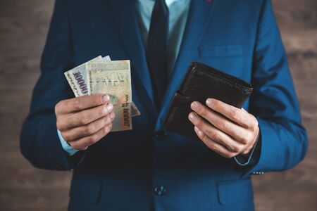 young man hand  holding money with wallet