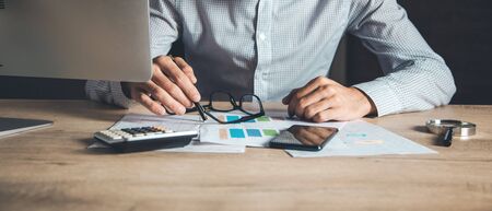 man hand document with computer on tableの写真素材