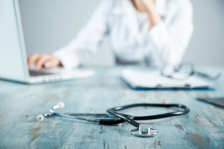 doctor working in computer on working deskの写真素材