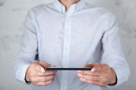 man hand smart phone on abstract background