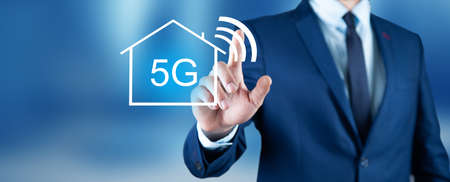 man hand touching 5G text in screenの写真素材