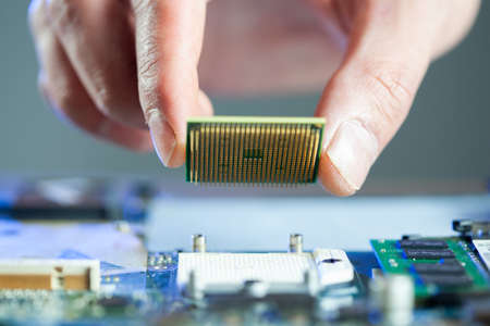 man hand chip with computer on desk