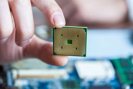 man hand chip with computer on desk
