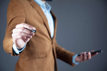 man hand phone with pen in screenの写真素材