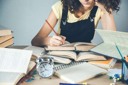 young girl hand books on desk backgroundの写真素材