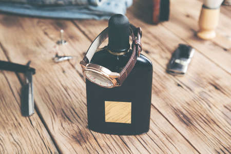 watch on perfume on the wooden desk backgroundの写真素材