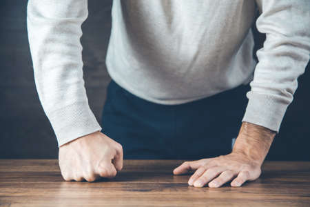 angry man fists on the desk backgroundの写真素材