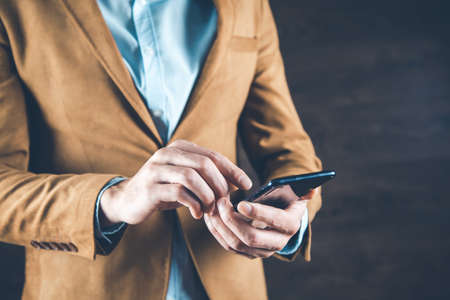 man hand smart phone on the dark backgroundの写真素材