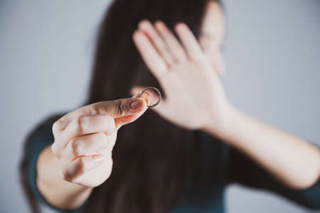 woman remove ring on the gray backgroundの写真素材