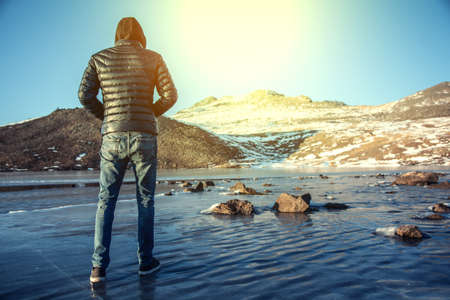man on the ice in mountain at the sunset