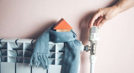 man hand with house model with scarf
