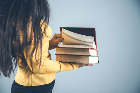 woman hand books on gray background
