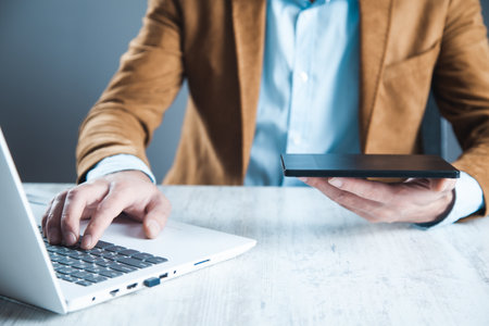 man hand tablet with keyboardon desk
