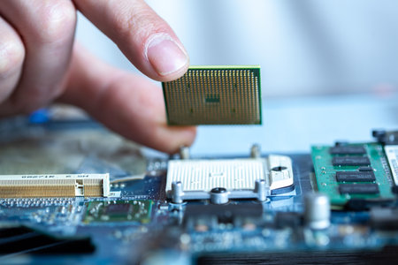 The technician is putting the CPU on the socket of the computer motherboard