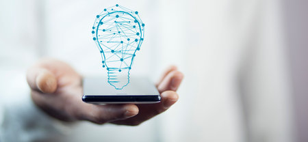 man hand phone with bulb in screenの写真素材