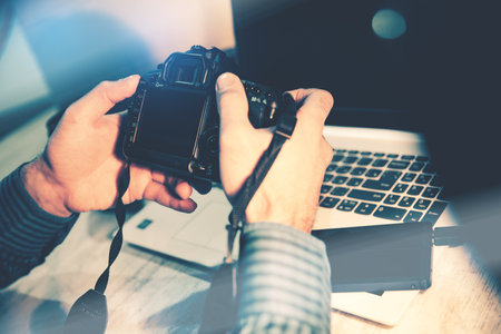 photographer hand camera on desk