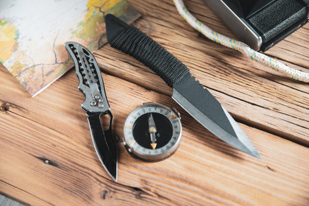 knife with compass on the wooden desk