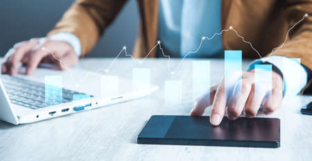 Businessman holding business graph with tablet