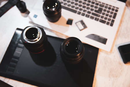 sd cards with lens and computer on deskの写真素材