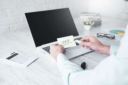 man hand idea text on desktop