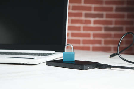 lock on tablet with computer on tableの写真素材