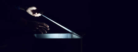 man with light box on the dark backgroundの写真素材