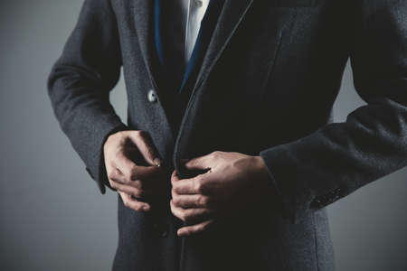 man hand suit button on dark backgroundの写真素材