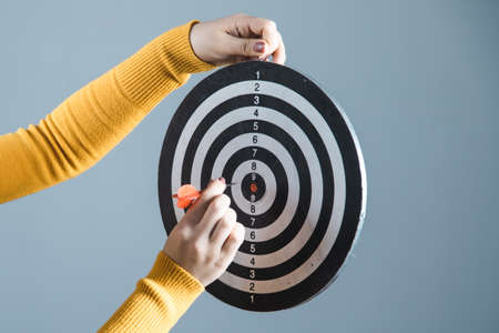 woman hand holding target on gray backgroundの写真素材