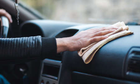 young man clean car in street backgroundの写真素材