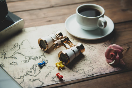 camera with map and coffee on the tableの写真素材