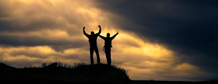 two men in rock at the sunset background