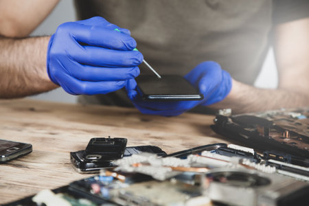 man worker to repair smart phone on the wooden tableの写真素材