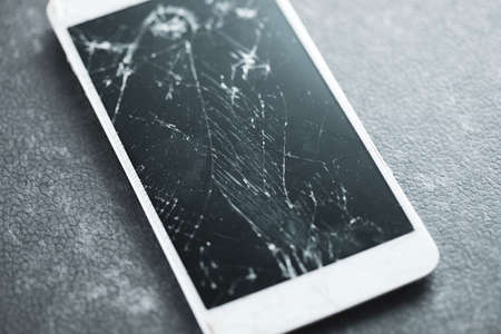 broken smart phone on the tableの写真素材