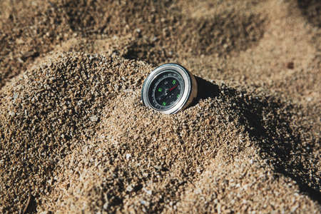 compass on sand with shiny dayの写真素材