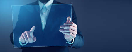 man touching in screen on the dark backgroundの写真素材