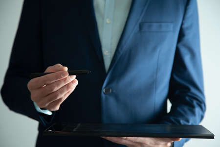 man hand holding tablet with pen in screenの写真素材