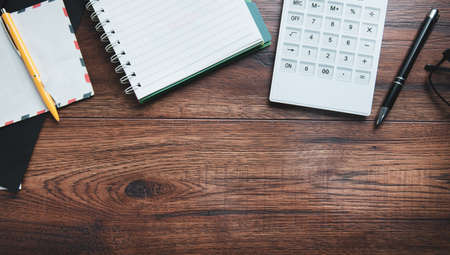 notepad with calculator and letters on desk