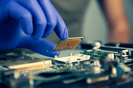 worker man hand holding motherboard on the tableの写真素材