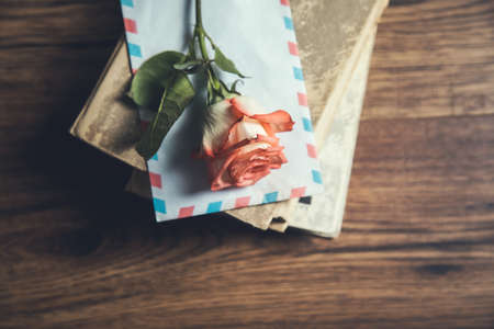 roses on letter on book on the table
