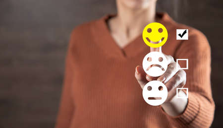 woman touching smiles in screen on dark background